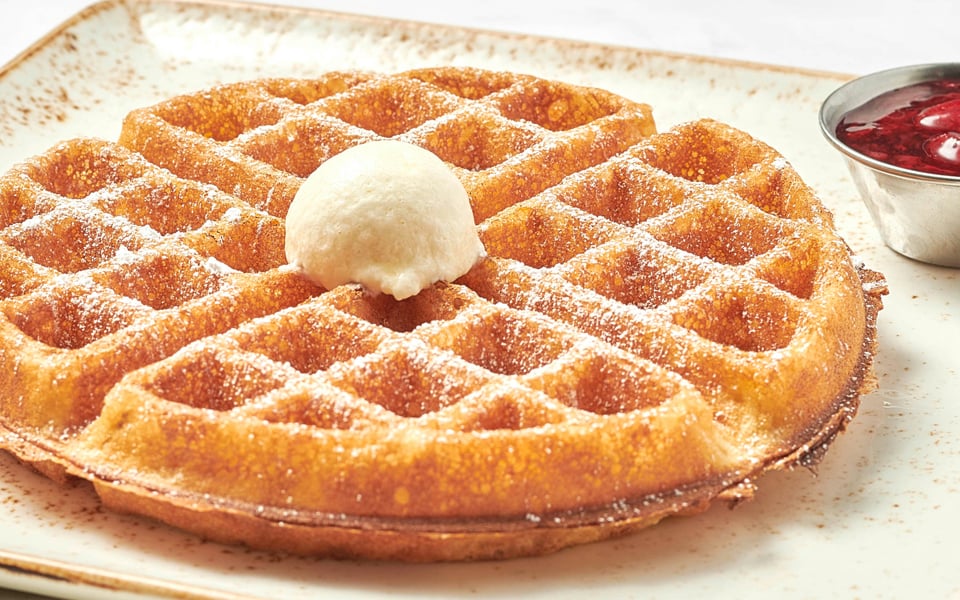 Our light and airy waffle with a side of warm mixed berry compote and powdered cinnamon sugar.