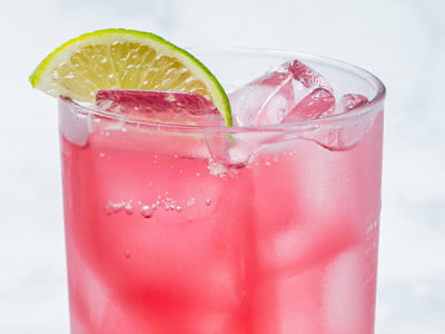 Wildberry puree, filtered sparkling water and a lime wedge.