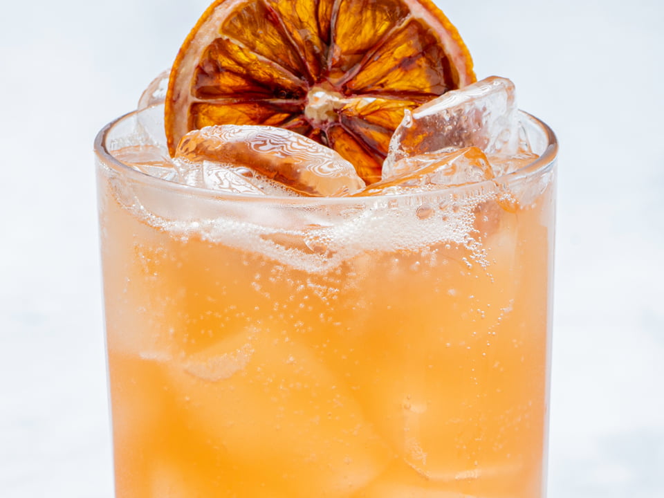 Blood orange puree, filtered sparkling water and a dried blood orange wheel.