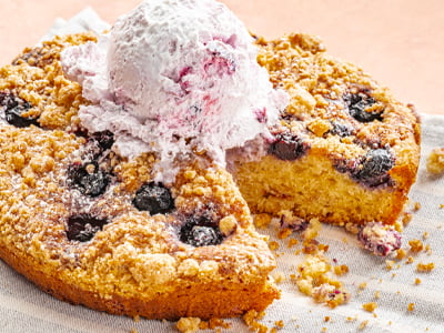 Freshly baked vanilla and blueberry crumb cake topped with a buttery streusel, sweet blueberry whipped cream and powdered cinnamon sugar.