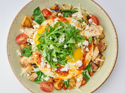 Grilled all-natural sliced chicken breast, diced red bell peppers, grape tomatoes, sauteed spinach and Mozzarella in a potato hash, topped with two cage-free eggs any style, herbed Goat cheese, lemon-dressed arugula and a drizzle of Calabrian chili oil.