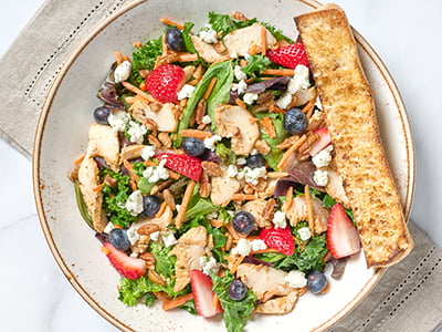 Vitamin-rich kale and organic mixed greens with all-natural sliced chicken breast, shredded carrots, fresh strawberries and blueberries, pecans and herbed Goat cheese tossed with lemon white balsamic dressing. Served with artisan ciabatta toast.