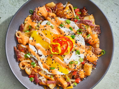 Breakfast hash with BBQ brisket, eggs, cheddar and monterey jack, and vegetables.