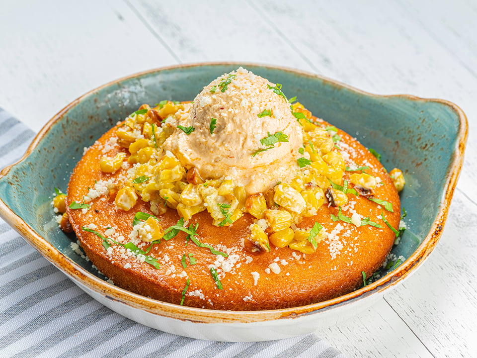 Freshly baked cornbread topped with jalapeño corn salsa, whipped chipotle-lime butter, Cotija cheese and fresh cilantro.
