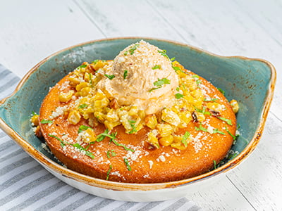 Freshly baked cornbread topped with jalapeño corn salsa, whipped chipotle-lime butter, Cotija cheese and fresh cilantro.