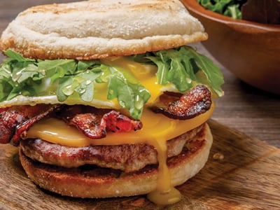 Million Dollar Bacon, a Jones Dairy Farm all-natural pork sausage patty, an over-easy cage-free egg, smoked Wisconsin Gouda, fresh arugula and Mike’s Hot Honey drizzled on a griddled English muffin. Served with lemon-dressed organic mixed greens.