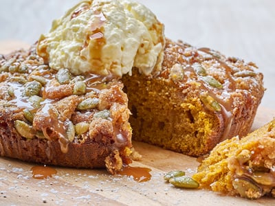 Freshly baked pumpkin spice coffee cake topped with a toasted pepita crumble, whipped cheesecake frosting and a sea salt caramel drizzle. Lightly dusted with powdered cinnamon sugar.