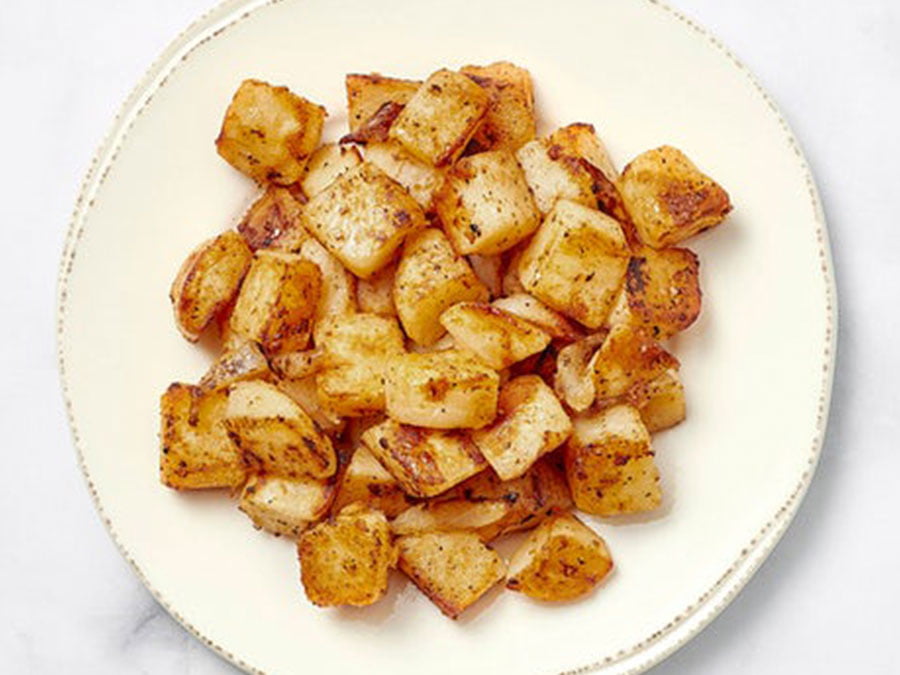 A plate of crispy, seasoned breakfast potatoes.