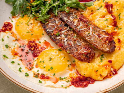 Griddled Italian pork sausage, two cage-free eggs any style and Bob’s Red Mill seasoned grits, topped with lemon-dressed arugula, fresh herbs and freshly grated Parmesan. Served with a side of chopped Calabrian chiles.