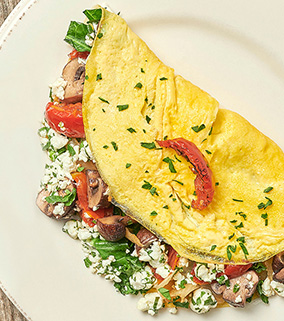 Morning Market Veggie Omelet, Kale, Sun-dried Tomatoes, Crimini Mushrooms and Herbed Goat Cheese